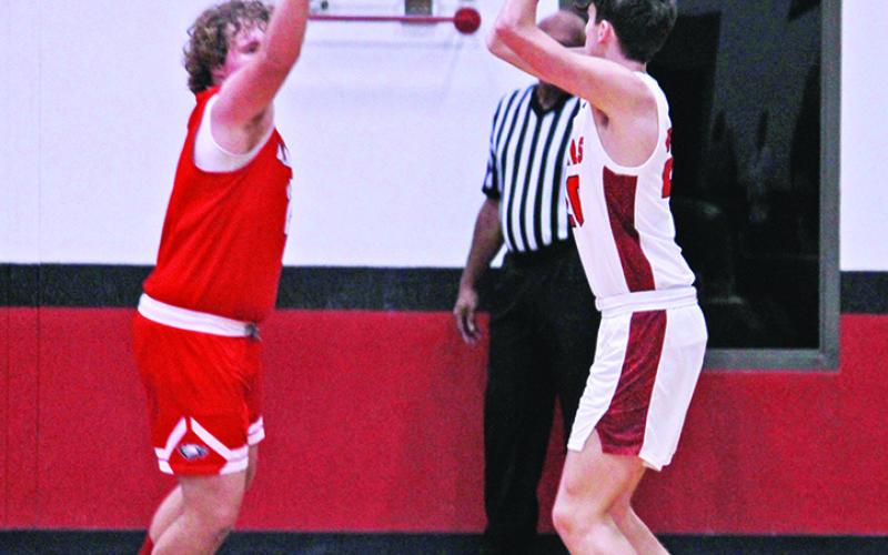 Max Daniel hoists a shot during Tuesday’s game. The eighth-ranked Chapel Hill Red Devils eased past Harmony, 82-36.