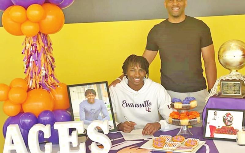 Zaveion Chism-Okoh signs his national letter of intent along with Mount Pleasant head basketball coach Joey Chism. PHOTO BY MELBARNEE CHISM-AUTRY