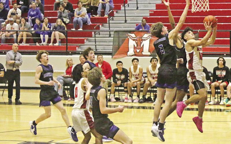 Chapel Hill’s Adrian Ramirez drives for a layup during Tuesday’s bidistrict game against Redwater. The Red Devils took on Jefferson in Friday’s area round game. TRIBUNE PHOTO / RYLEIGH STEGALL