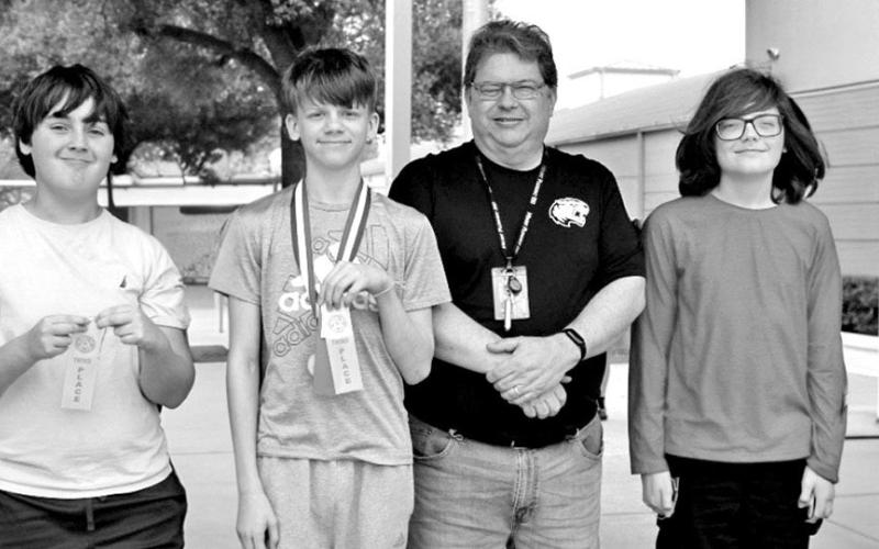 Calculator (L to R) Tristan Kirkland, Macon Bradshaw, Coach Terry Fitch, JC Moss