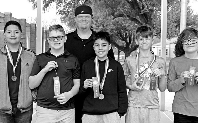 Chess puzzle solving (L to R) Omar Castaneda, Tristan Henderson, Coach Jared Erickstad, Yaden Villanueva, Macon Bradshaw, JC Moss