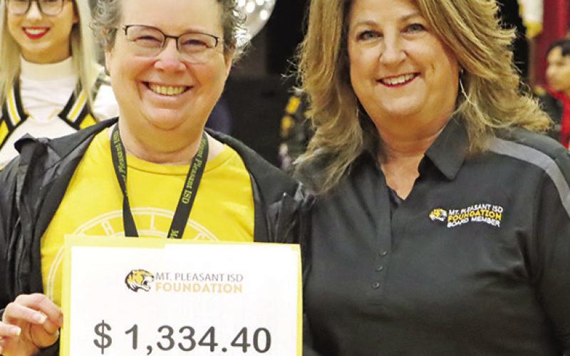 P.E. Wallace Middle School robotics coach, Tara Flores (left), happily accepts her $1334.40 grant for VEX Robots competition upgrade kits from Foundation member, Tonya Murray. COURTESY PHOTOS
