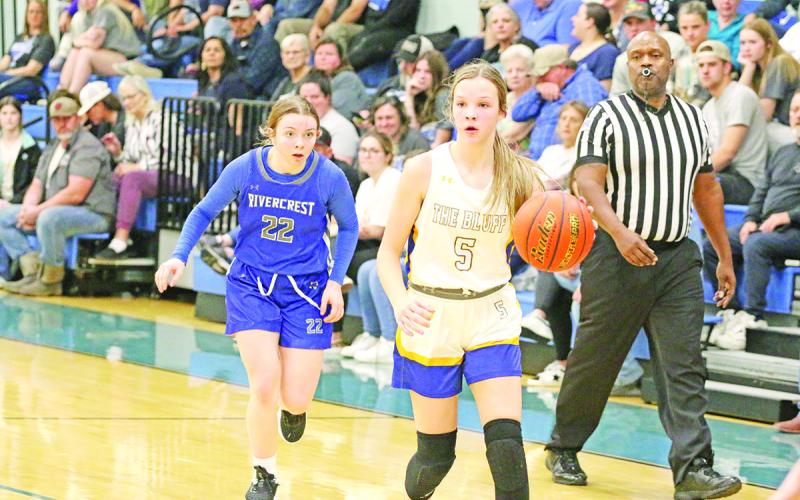 Rivercrest’s Anna Duvall chases Harts Bluff’s Kaylee Clay during Tuesday’s game. The Lady Rebels defeated the Lady Bulldogs, 56-22.