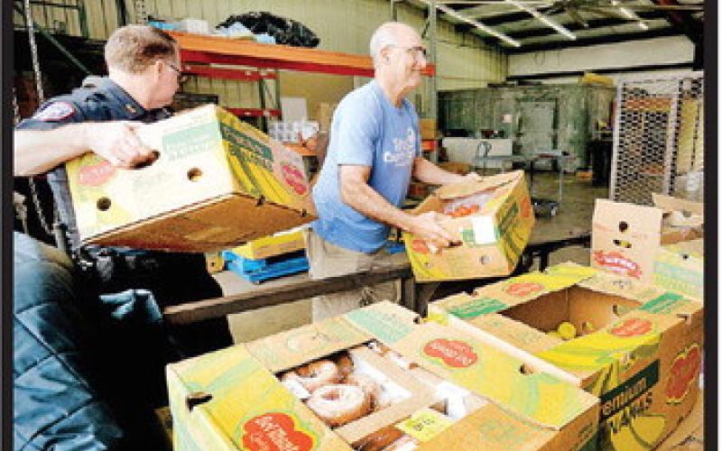 It was a wonderfully-busy morning at Titus County Cares as another delivery of produce also arrived, and volunteers were able to help unload. COURTESY PHOTO