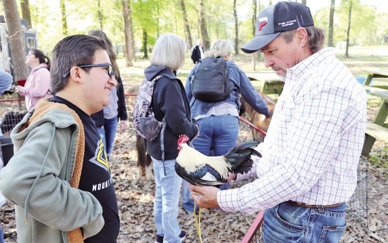 A volunteer tells Jazziel Resendiz about some of the animals that live on the ranch