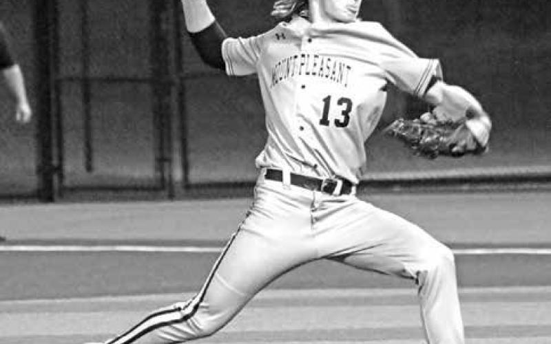 Bennett Wall (13) delivers a pitch for the Tigers on Monday night. Wall pitched two innings in relief to earn the victory.