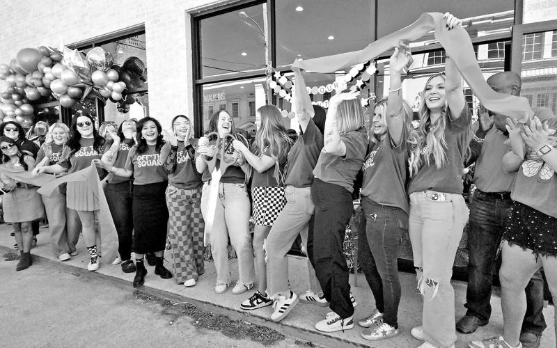 Staff, family, and friends cheer as the ribbon is cut for ‘Off the Square’ TRIBUNE PHOTO / NICOLE KIMBALL