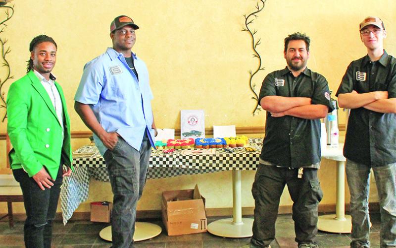 Left to right: NTCC Director of Student Development and Inclusion Kaymon Farmer, Shelby Club President Brandon Fuller, Daryl “Frito” Bevins, and Kolby Perkins beside a cupcake desert commemorating Carroll Shelby’s 100th birthday. Bevins and Perkins are students in the Shelby Automotive Program. They are also Work 4 College students and are majoring in mechanics. TRIBUNE PHOTO / ELIZABETH LANNING