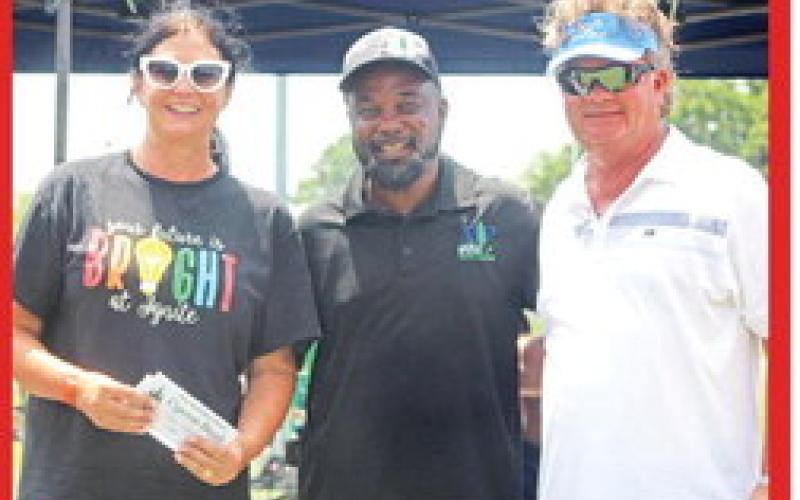 Mayor Tracy Craig, center, congratulates local business owners and philanthropists Ricky and Kelly Baker for taking top honors at the Juneteenth SATURDAY Celebration Car Show in 2022. COURTESY PHOTOS