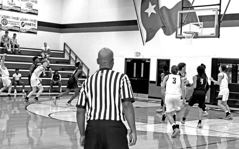 #11 Jace Sullivan shoots a three pointer from the far side against the 5A Tyler Lions.