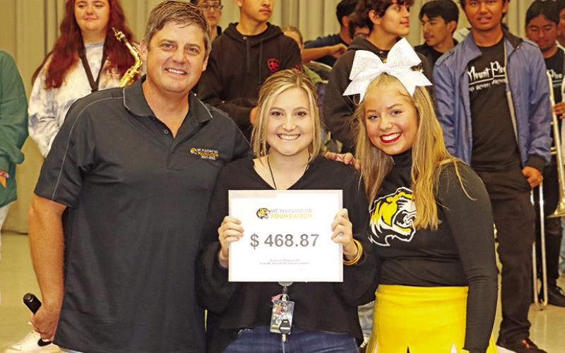 Brice teacher, Kendel Thompson (center), receives a grant from her dad and Foundation member, Dr. Kenny Thompson (left), and her sister, Kit Thompson (right)
