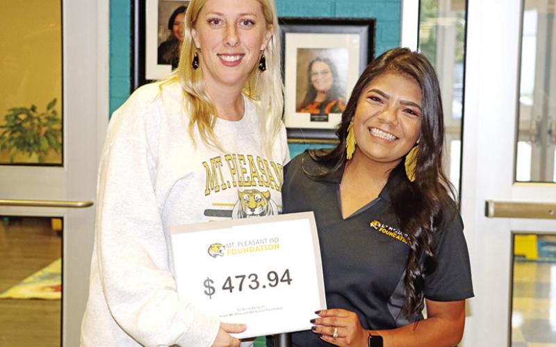 Fowler teacher, Kristi Berry (left), receives a grant from MPISD Foundation member, Suzy Castillo (right)