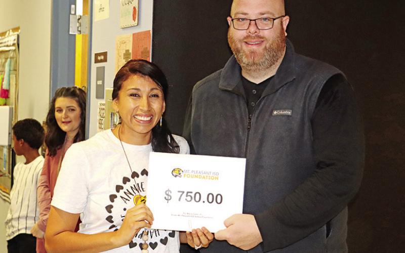 Sims teacher, Maria Cates (left), receives a grant from Foundation member, Jeremy Thomas (right)