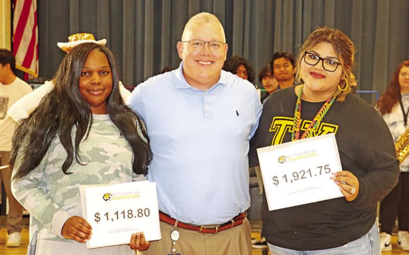 Corprew teachers Tameca Martin (left) and Liliana Ybarbo (right) receive grants for keyboards and computer accessories from MPISD Superintendent, Judd Marshall