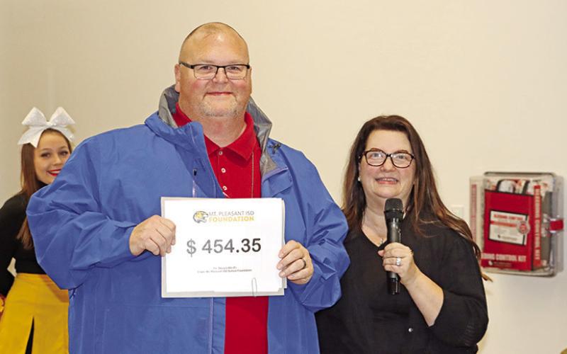MPHS Math teacher, Doug Little (left), receives a grant for document cameras and color graphing calculators from Foundation President, Amy Hinton (right)
