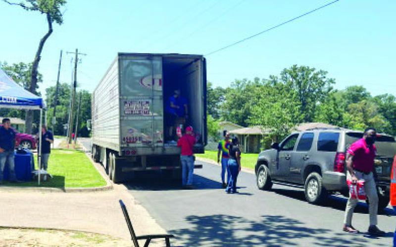 Cars were lined up Friday at Oaklawn Park as Pilgrim’s Pride hosted a community product giveaway. For more photos, see page 2. TRIBUNE PHOTOS / MIRANDA OGLESBY