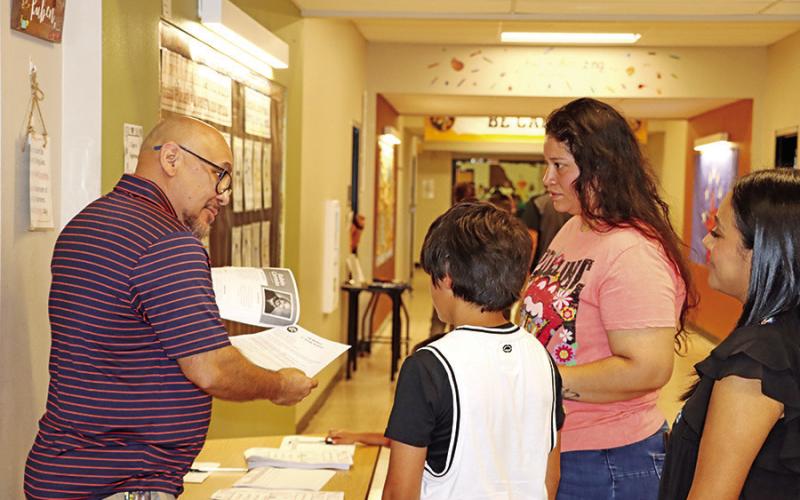 Wallace teacher, Ruben Carreon, discussed dual language science and social studies with an new sixth grader