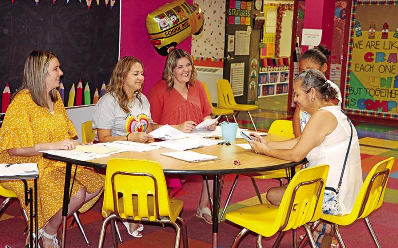 Corprew teachers (l - r) Amanda Phillips, Aide Perez, and Jessica Williams went over information about their third grade dual language team