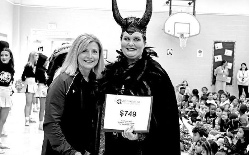 Deb Malone presents a grant to Maleficent, a.k.a. Christy Moss, at Vivian Fowler