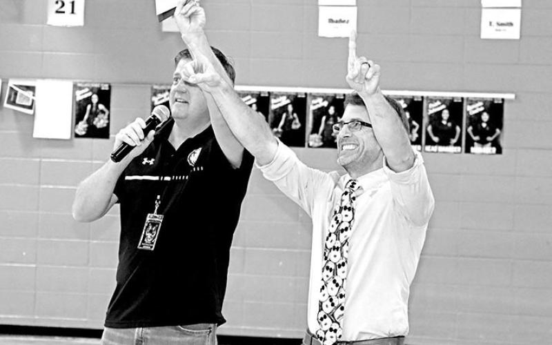 Wallace teacher Jason Barfield (right) celebrates receiving a grant from Dr. Kenny Thompson