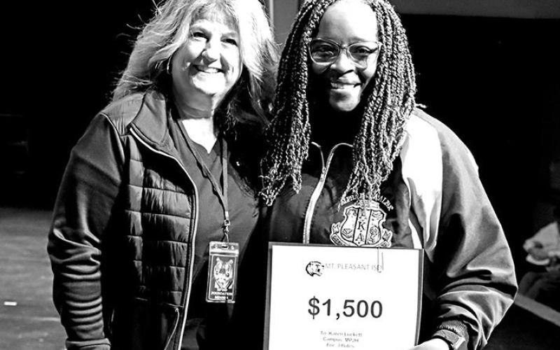 Tonya Murray (left) presents a grant to Karen Luckett, MPJH Director of Bands, for some additional flutes