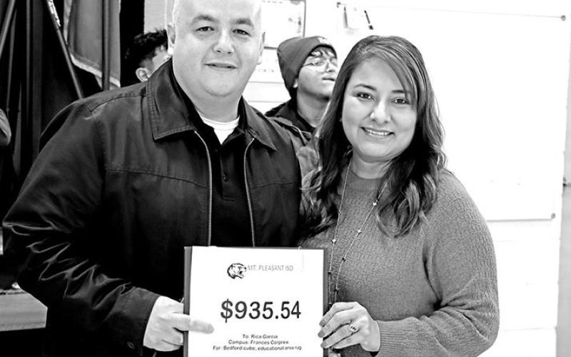 Martin Acuna presents a grant to Rica Garcia at Frances Corprew