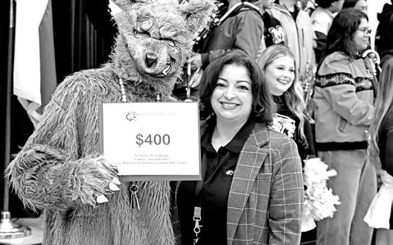 The Big Bad Wolf, a.k.a. Patsie DeSantiago, took time away from Little Red Riding Hood to accept a grant from Eva Beles