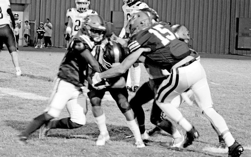Pewitt’s KD Watson (left), Trace Goforth (right) and JD Smith (right, background) combine to bring down a ball carrier during a recent game. The Brahmas will look for their first win Friday night at Redwater. BEE PHOTO / QUINTEN BOYD