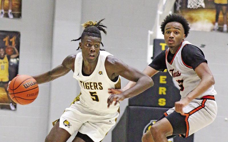 Mount Pleasant’s Reggie Webster (5) gets past a Texas High defender during Friday night’s home game.