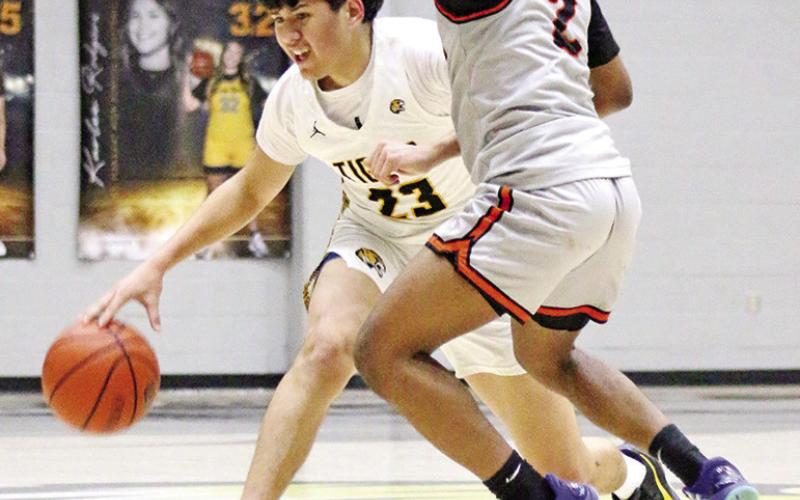 Mount Pleasant’s Alex Guerrero (23) dribbles down court during Friday night’s win over visiting Texas High.