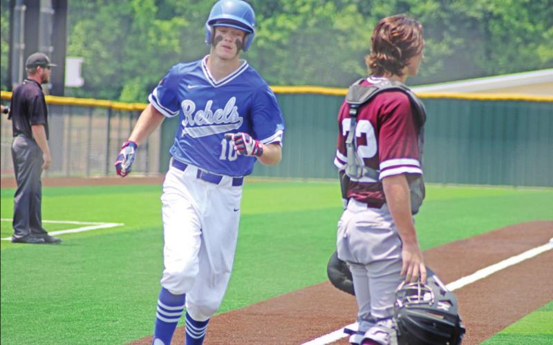 Dylan Earley crosses home plate for a Rivercrest run during game three of their series against Maud. Rivercrest won game three, 12-2, and won the series, 2-1.