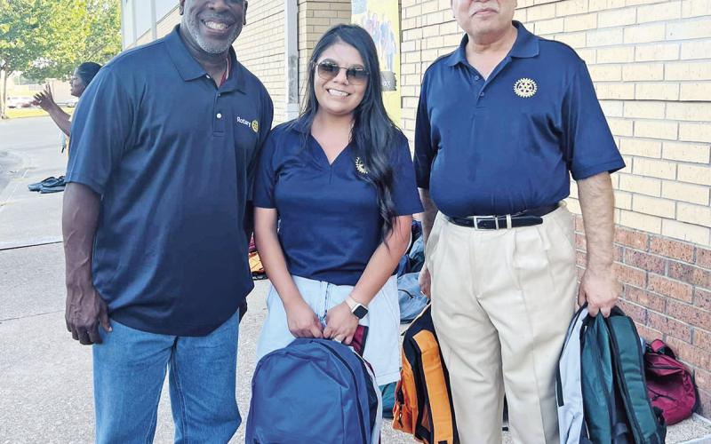 Rotarians volunteered to hand out backpacks during the drive-through event.