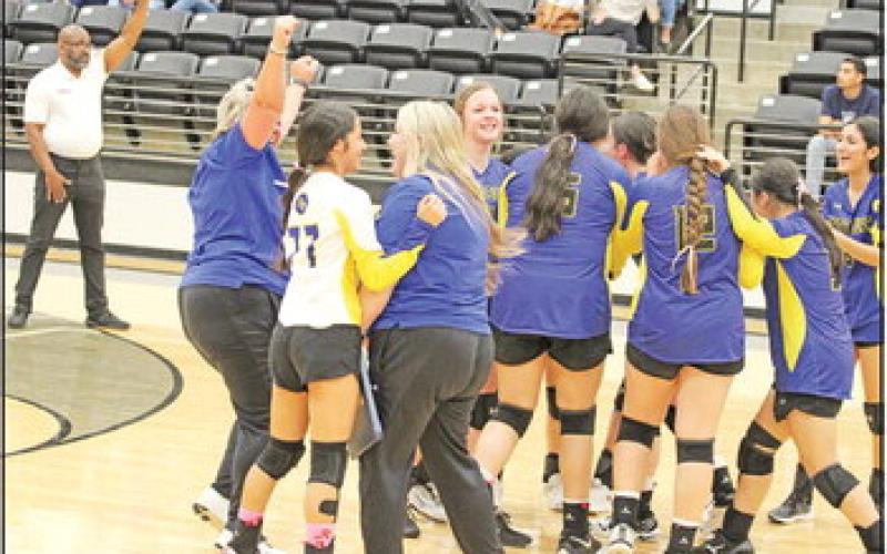 The Harts Bluff volleyball team celebrates with Head Coach Sivi Cheek and assistant coach Niki Cheek following their playoff win over Ore City. Harts Bluff will take on defending state champion Beckville in the area round.