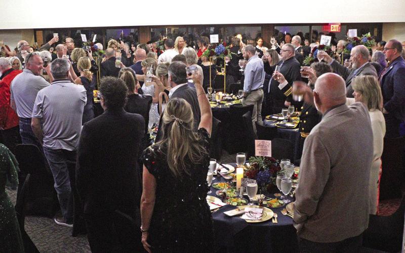 Guests raise a toast recognizing those who have served the country.