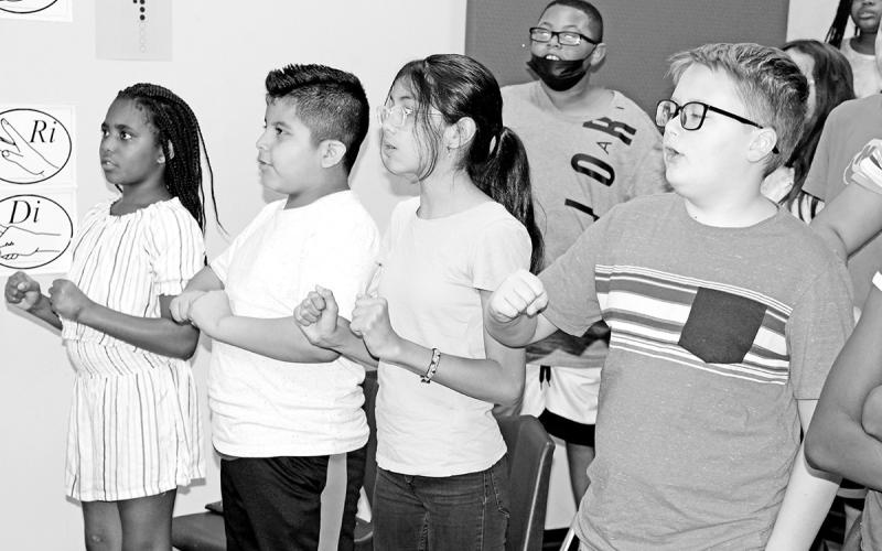 (Front L to R) Jariyah Brown, Mateo Canada, Mia Carrillo, Gunner Craig and (back left) Jaiden Edwards warm up by practicing reading music