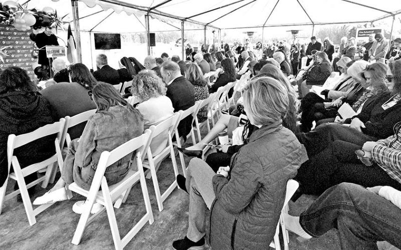 Friends and family bow their heads in prayer