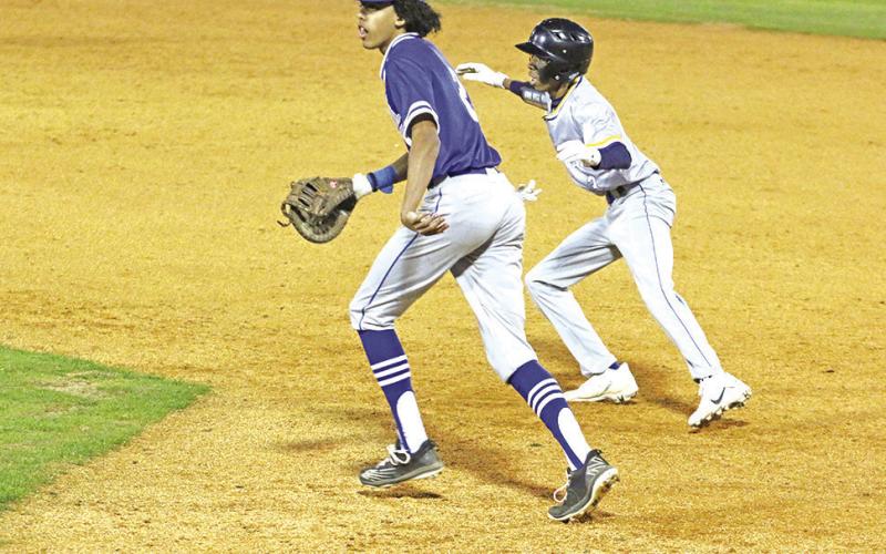 Harts Bluff’s Brayden Craddock prepares to run as Rivercrest’s Tre Williams sets up defensively. The teams will meet again April 7 at Rivercrest. TRIBUNE PHOTOS / QUINTEN BOYD
