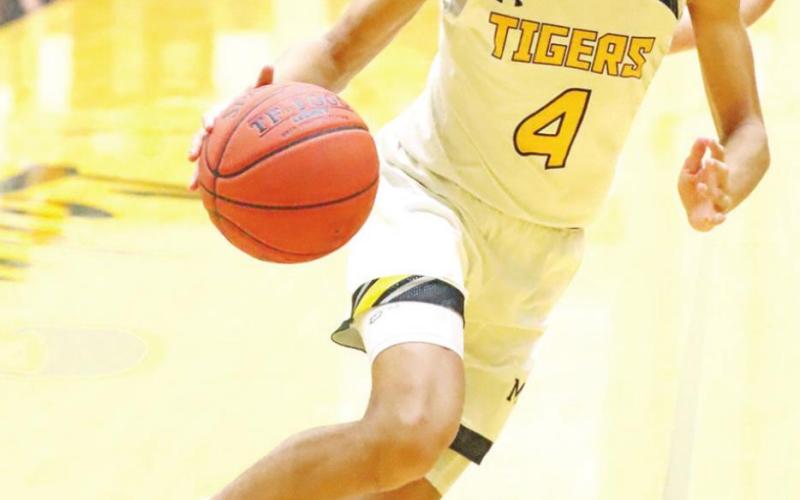 Kai Price drives to the basket. PHOTO BY JOHN WHITTEN