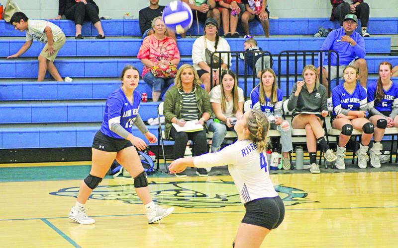 Rivercrest’s Logan Huddleston prepares for a bump as teammate Stoney Carey looks on during a recent match. Rivercrest traveled to Clarksville Tuesday and will open the second round of district play Friday at home against Harts Bluff. TRIBUNE PHOTO / QUINTEN BOYD