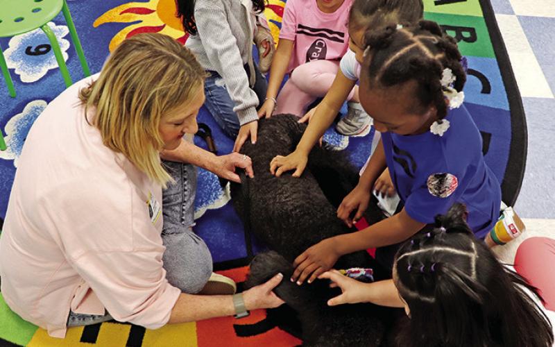 Charla Bowen lets students interact with Therapy Dog, Georgia