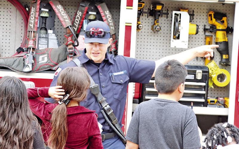A local Firefighter explains the equipment carried on a firetruck