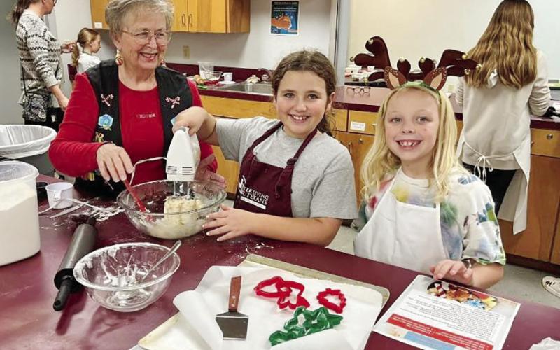 Lilly Cameron and Rayne Pitts mix things up during the Titus County 4-H cooking class. COURTESY PHOTO / CALLIE ZOELLER
