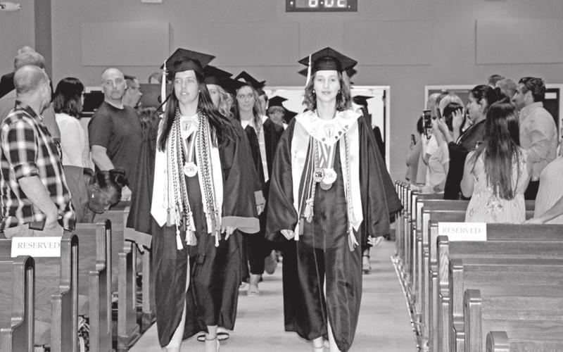 Chapel Hill Salutatorian, Presley Applegate, and MPHS Valedictorian, Connelly Cowan, lead the graduates into the sanctuary. COURTESY PHOTO