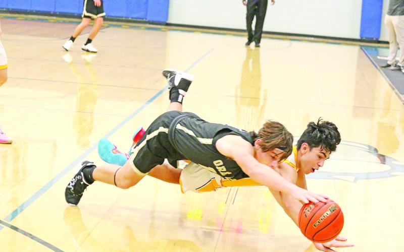 Harts Bluff’s Isaac Anguiano and Ore City’s Gage Cavanaugh dive for a loose ball during their matchup. The Bulldogs won both their games last week, defeating the Rebels and Union Grove. TRIBUNE PHOTOS / QUINTEN BOYD