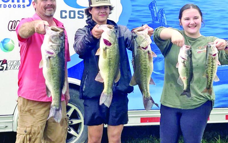 Boat Captain James Dunn (left), Kamen Dunn (center), and Khloe Dunn (right) display their 5 fish