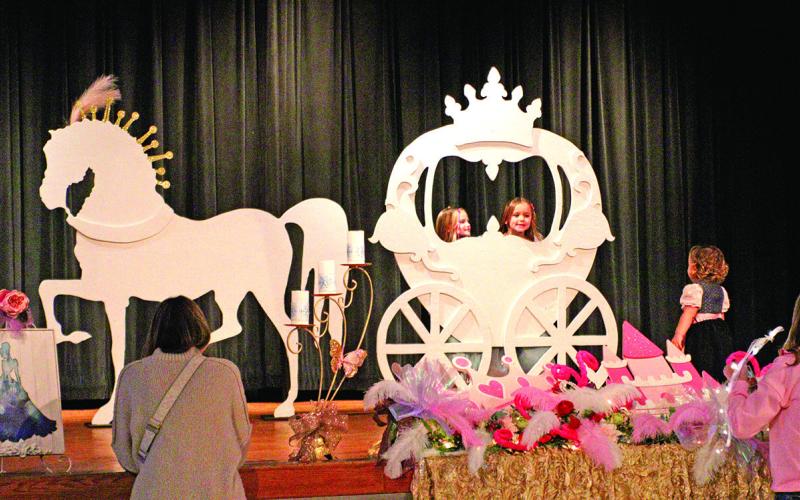 Girls dressed as princesses pose for magical picture op.