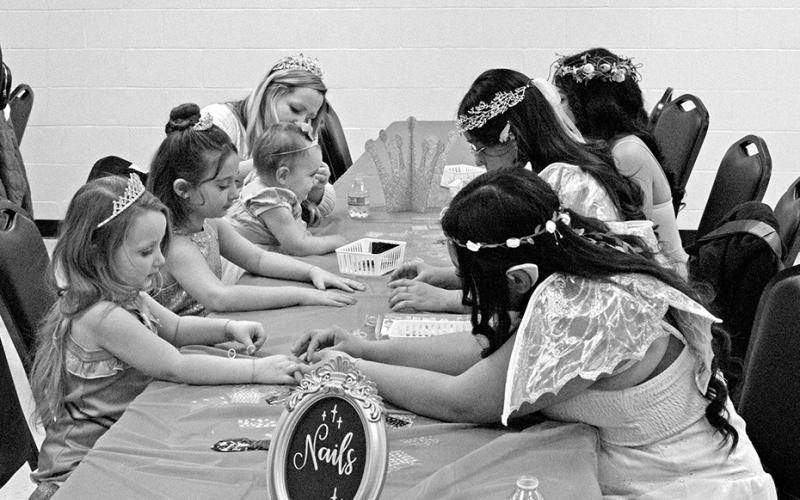 Volunteers offer nail salon services for little princesses.