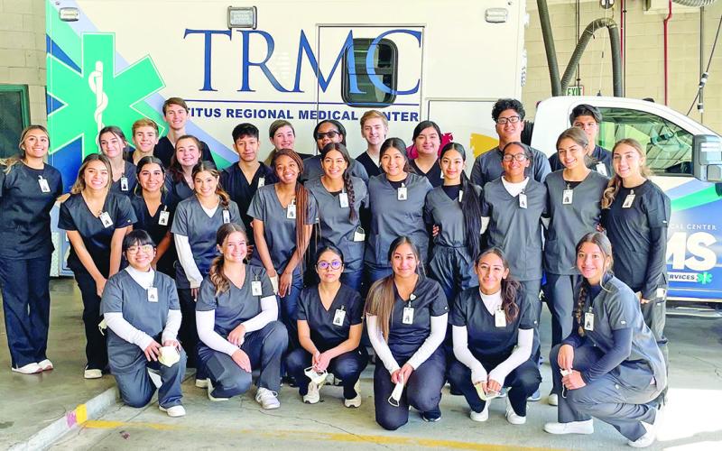 Practicum II students pose in front of TRMC Ambulance in the bay after completing the tour. COURTESY PHOTO