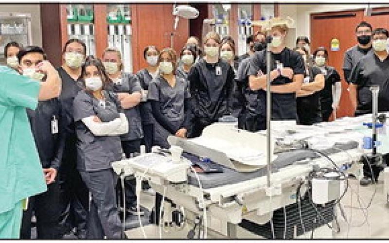 TRMC Cath Lab employees, Adam Larson and Michael Seanz, explain the process of completing patient care. COURTESY PHOTOS