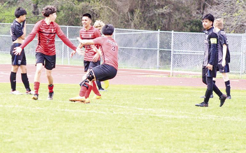 From left, Chapel Hill’s Rodrigo Olvera celebrates with Omar Morales and A.J. Ramirez following Olvera’s goal during the Red Devils’ game against Sulphur Springs Saturday afternoon. The Devils scored twice in the second half but fell against the Wildcats, 4-2. The Devils traveled to Liberty-Eylau Tuesday and will play their home finale Friday against Pleasant Grove before concluding their season next Tuesday at Paris. TRIBUNE PHOTO / QUINTEN BOYD